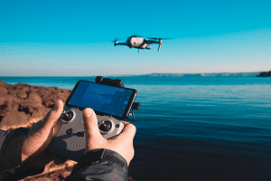 A man flying a camera drone 
