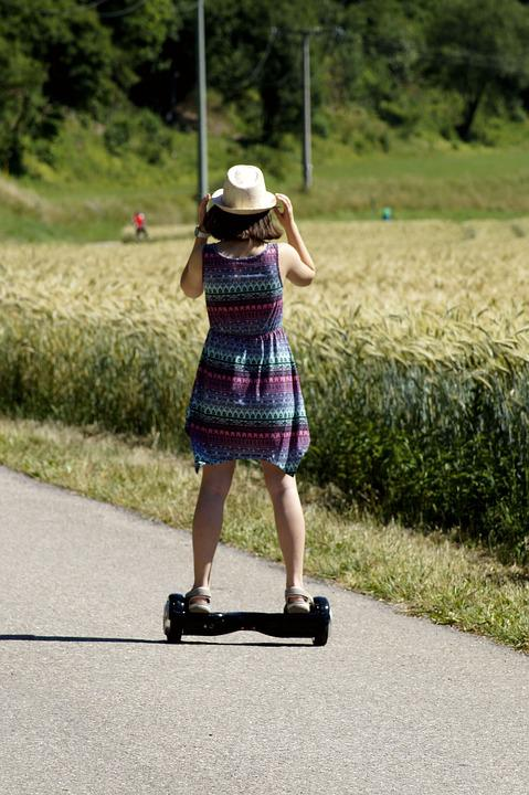 A girl is riding on a hoverboard